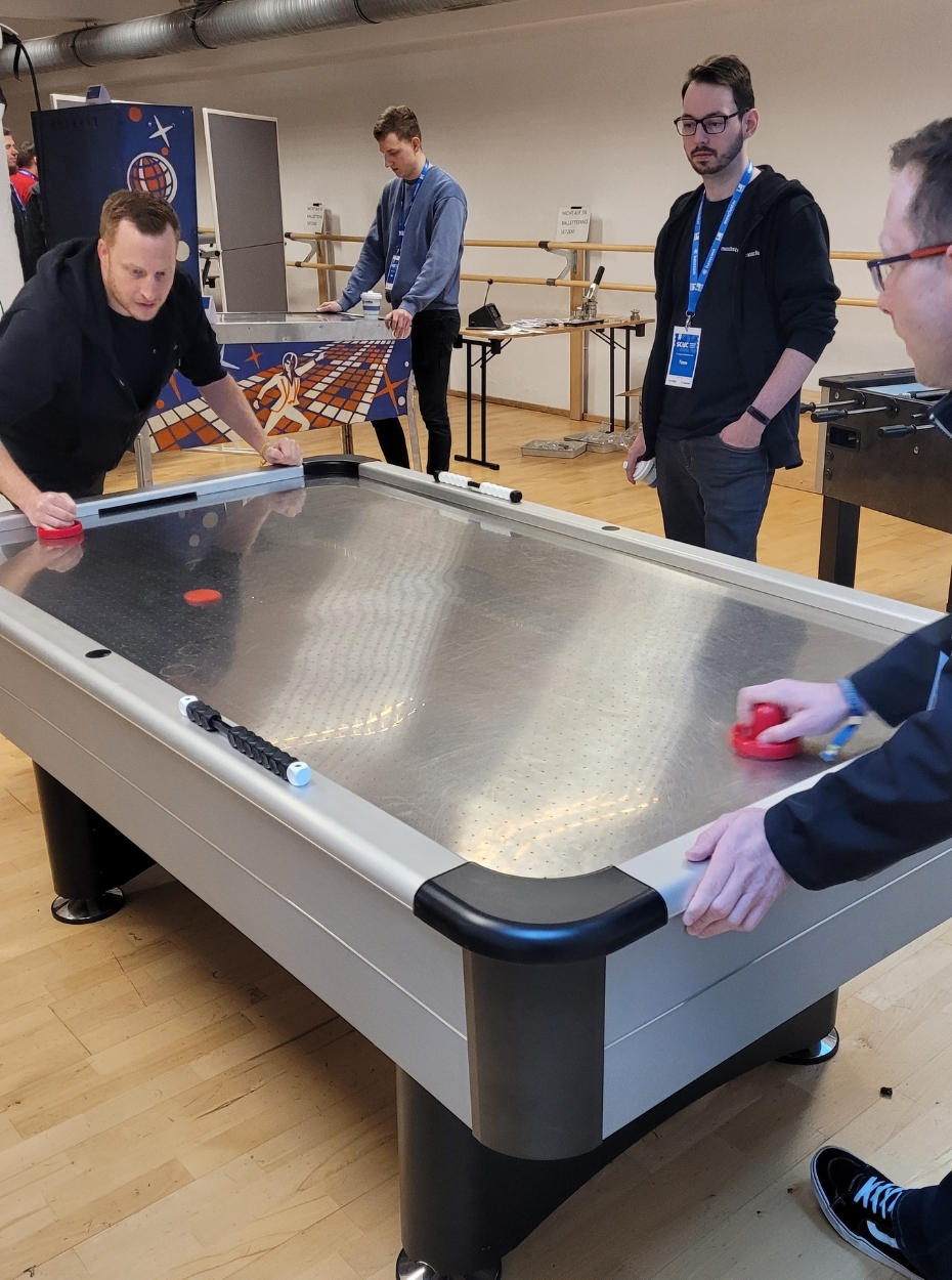 The maxcluster team playing air hockey.