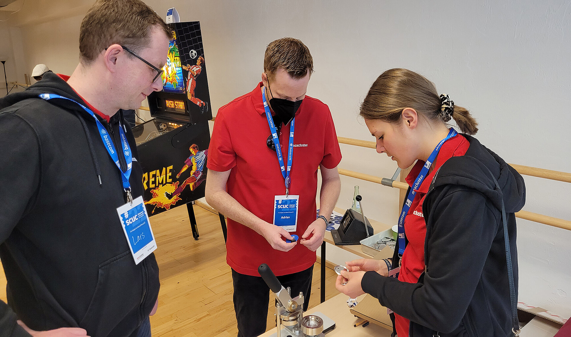 Our team in action at the button machine.